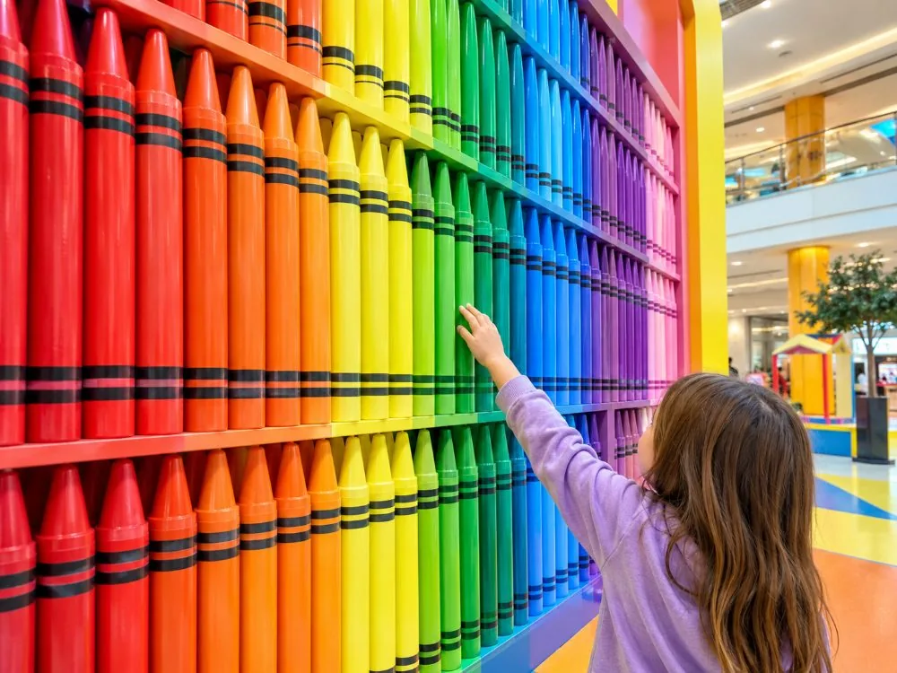 A wall of crayons sorted by colour at Crayola Experience